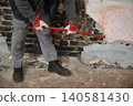 Adult worker demolish old house 140581430