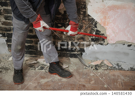 Adult worker demolish old house 140581430