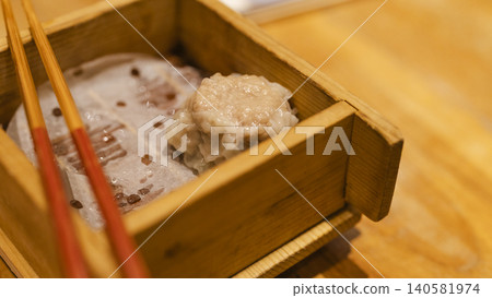 Steamed dumplings in bamboo steamer 140581974
