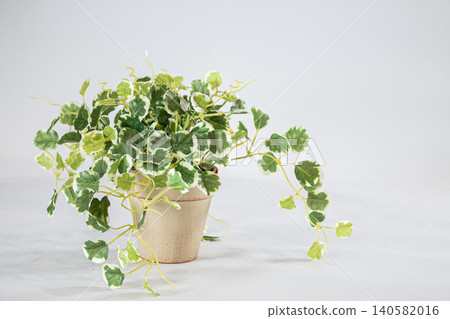 Artificial flowers and greenery displayed indoors. 140582016
