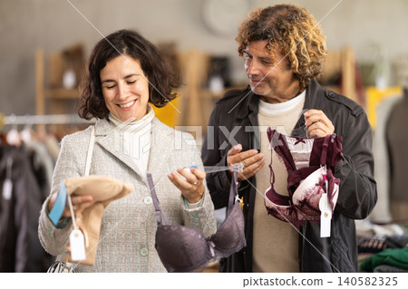 Married couple woman and man search and choose bra Married couple woman and man search and choose bra 140582325