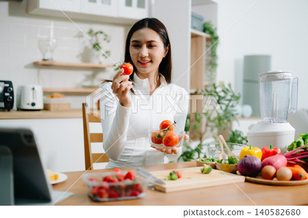 Healthy woman preparing fresh vegetables at home kitchen. Clean eating, nutrition, cooking, wellness lifestyle, vegetarian food, diet concept and healthy living inspiration. Healthy woman preparing fresh vegetables at home kitchen. Clean eating, nutrition, cooking, wellness lifestyle, vegetarian food, diet concept and healthy living inspiration. 140582680