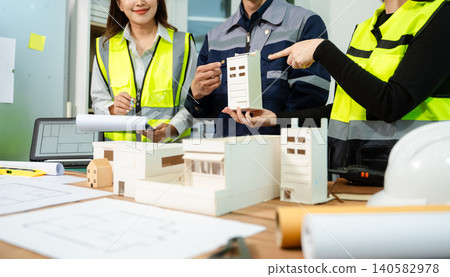 Engineer teams meeting working together wear worker helmets hardhat on construction site Engineer teams meeting working together wear worker helmets hardhat on construction site 140582978
