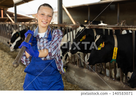 Young woman farmer with pitchfork on farm Young woman farmer with pitchfork on farm 140583071