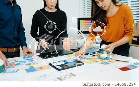 Close up view of UI developer team brainstorming on their project with laptop, smartphone and digital tablet. Close up view of UI developer team brainstorming on their project with laptop, smartphone and digital tablet. 140583254