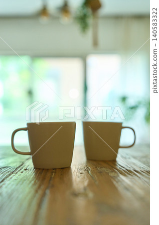 Two mugs lined up on the table in the room Two mugs lined up on the table in the room 140583322