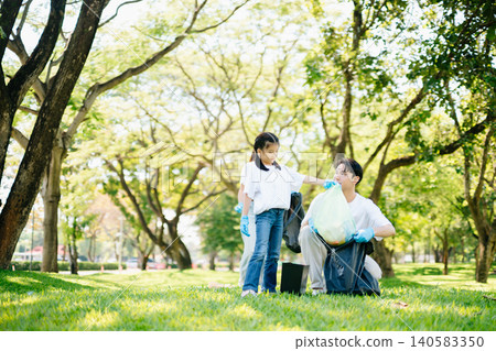 Joyful family volunteering to clean up a green park together. A positive lifestyle scene promoting eco-awareness, teamwork, and love for nature. Joyful family volunteering to clean up a green park together. A positive lifestyle scene promoting eco-awareness, teamwork, and love for nature. 140583350