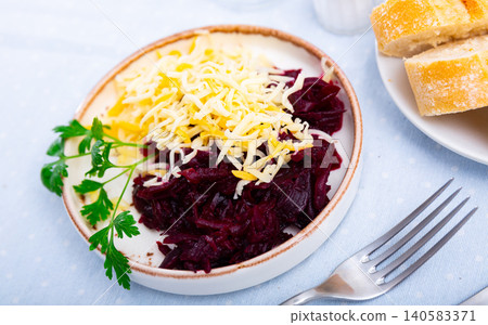 Vitamin salad with beetroot, cheese and parsley on wooden background Vitamin salad with beetroot, cheese and parsley on wooden background 140583371
