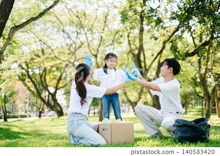 Joyful family volunteering to clean a park together. A heartwarming outdoor scene promoting teamwork, love, and environmental awareness in a green lifestyle. Joyful family volunteering to clean a park together. A heartwarming outdoor scene promoting teamwork, love, and environmental awareness in a green lifestyle. 140583420