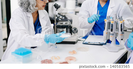 Dynamic scene of food scientists using microscopes and pipettes in a lab, Dynamic scene of food scientists using microscopes and pipettes in a lab, 140583565