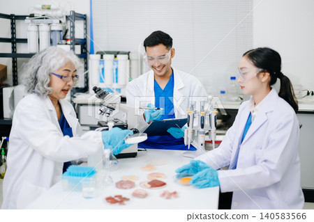 Team of Diverse Asian Scientists Conducting Research in Modern Laboratory 140583566
