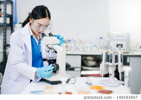 Food science as lab scientists test and analyze vegetables for safety and quality using advanced technology and precise equipment. 140583607