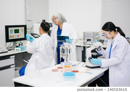 Dynamic scene of food scientists using microscopes and pipettes in a lab, Dynamic scene of food scientists using microscopes and pipettes in a lab, 140583610