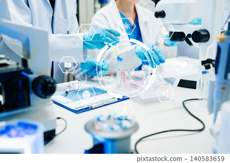Scientist Team Working in Medical Laboratory with Futuristic HUD Interface 140583659