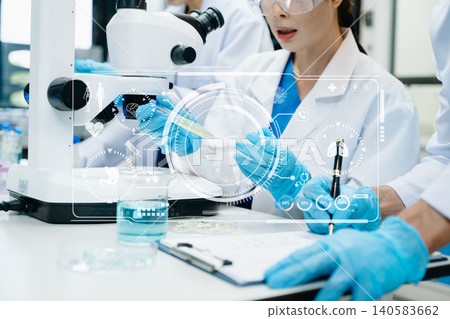 Scientist Team Working in Medical Laboratory with Futuristic HUD Interface Scientist Team Working in Medical Laboratory with Futuristic HUD Interface 140583662
