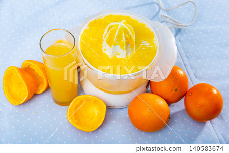 Electric orange juicer white on wooden table Electric orange juicer white on wooden table 140583674