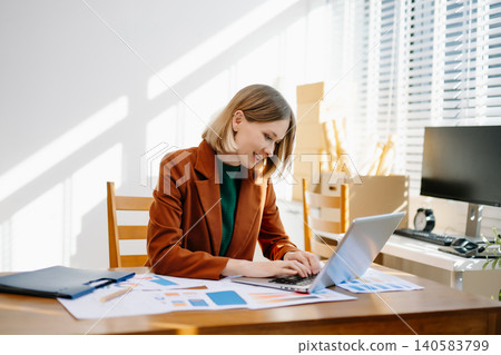 Female designer choosing a color palette while working on a creative project in a bright modern workspace. Female designer choosing a color palette while working on a creative project in a bright modern workspace. 140583799