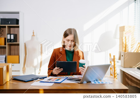 Female designer choosing a color palette while working on a creative project in a bright modern workspace. Female designer choosing a color palette while working on a creative project in a bright modern workspace. 140583805