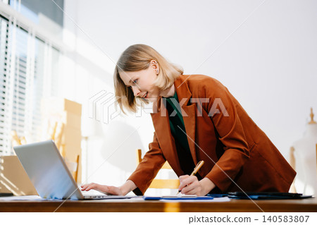 Designer selecting color palette while working on a creative branding project in a modern bright workspace. 140583807