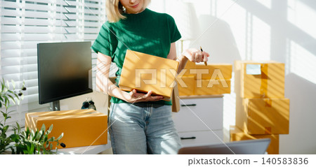 Young business owner woman prepare parcel box and standing check online orders for deliver to customer on tablet, laptop Shopping Young business owner woman prepare parcel box and standing check online orders for deliver to customer on tablet, laptop Shopping 140583836