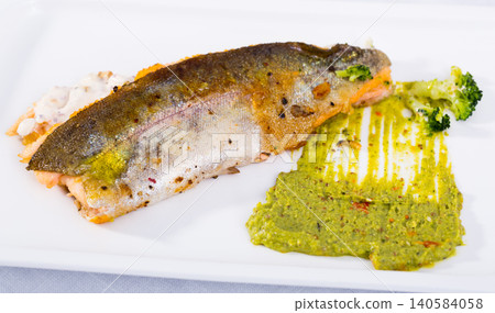 Tasty steak of fried river trout fillet with sause tartar on plate 140584058