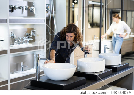 Confident male customer choosing bathroom sink in hardware store 140584059