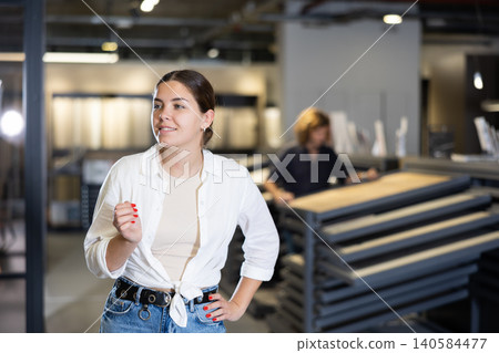 Confident woman picking new bathroom wall furnishing materials in hardware store Confident woman picking new bathroom wall furnishing materials in hardware store 140584477