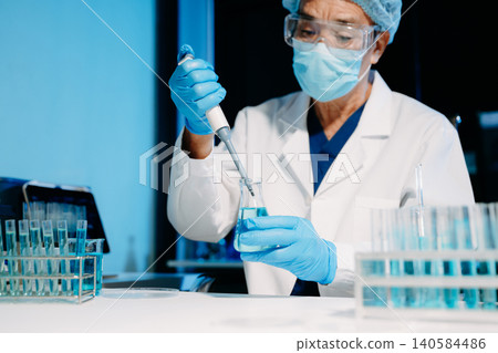 Scientist mixing chemical solutions in a modern laboratory, showcasing biotech innovation, chemistry research, diagnostics, and scientific development. Scientist mixing chemical solutions in a modern laboratory, showcasing biotech innovation, chemistry research, diagnostics, and scientific development. 140584486