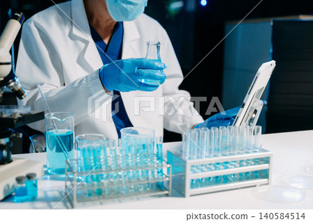 Scientist using a micropipette to handle samples in a modern laboratory, showcasing biotech research, medical diagnostics, and scientific innovation. Scientist using a micropipette to handle samples in a modern laboratory, showcasing biotech research, medical diagnostics, and scientific innovation. 140584514