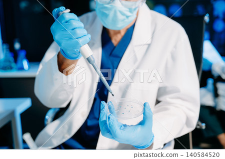 scientists in lab coats conducting research, handling glassware, and working with chemicals in a modern, high tech laboratory. scientists in lab coats conducting research, handling glassware, and working with chemicals in a modern, high tech laboratory. 140584520