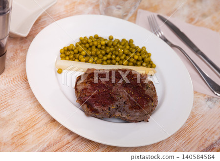 Dish of fried beef steak with green peas Dish of fried beef steak with green peas 140584584