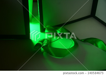 Abstract composition of a green ribbon forming an infinity symbol with neon Abstract composition of a green ribbon forming an infinity symbol with neon 140584673