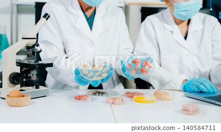 Scientists developing lab grown meat in food science laboratory. Biotechnology research on sustainable protein, alternative agriculture and future food Scientists developing lab grown meat in food science laboratory. Biotechnology research on sustainable protein, alternative agriculture and future food 140584711