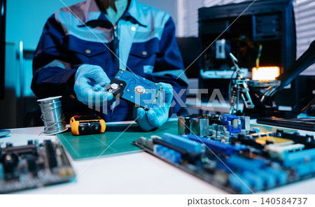 Technician repairing inside of hard disk drive by screwdriver. the concept of data, hardware, technician and technology. computer hardware, repairing, upgrade Technician repairing inside of hard disk drive by screwdriver. the concept of data, hardware, technician and technology. computer hardware, repairing, upgrade 140584737
