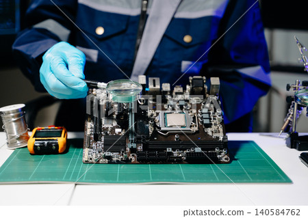 Professional senior technician holding and inspecting computer motherboard at high-tech electronics repair workstation Professional senior technician holding and inspecting computer motherboard at high-tech electronics repair workstation 140584762