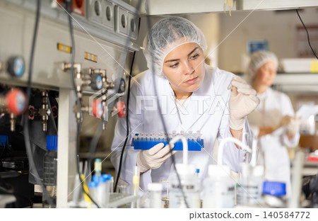 Shot of an young woman using equipment to work in a laboratory Shot of an young woman using equipment to work in a laboratory 140584772