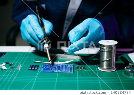 Professional technician soldering PCB circuit board with precision tools in electronics lab, showcasing hardware engineering, manufacturing, repair Professional technician soldering PCB circuit board with precision tools in electronics lab, showcasing hardware engineering, manufacturing, repair 140584784