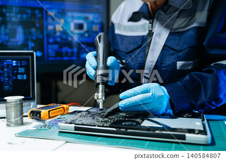 Technician performing PCB soldering and diagnostics with multimeter in electronics lab, showcasing hardware engineering Technician performing PCB soldering and diagnostics with multimeter in electronics lab, showcasing hardware engineering 140584807