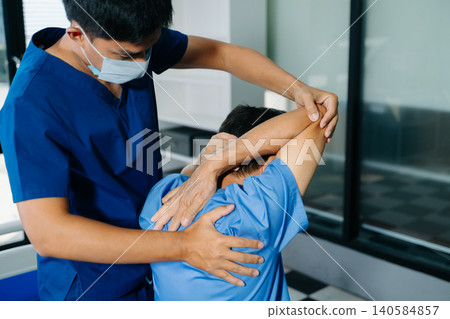 Elderly patient receiving physiotherapy for shoulder recovery. Senior healthcare, mobility support and active aging rehabilitation concept Elderly patient receiving physiotherapy for shoulder recovery. Senior healthcare, mobility support and active aging rehabilitation concept 140584857