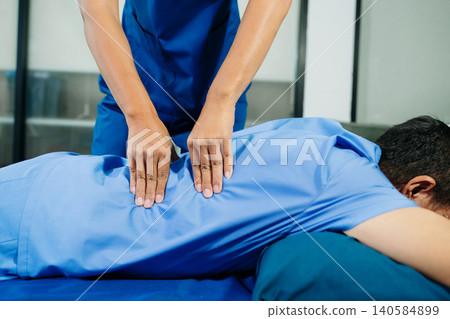 Close up of Physiotherapist working with patient on the bed in clinic Close up of Physiotherapist working with patient on the bed in clinic 140584899