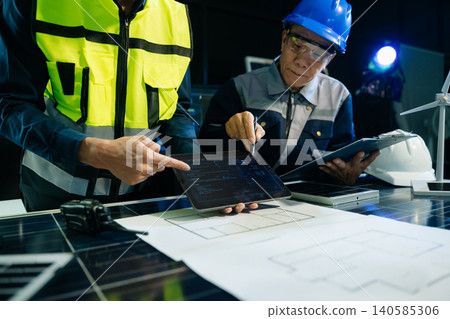 Asian engineer team analyzing industrial solar energy systems and clean power solutions 140585306