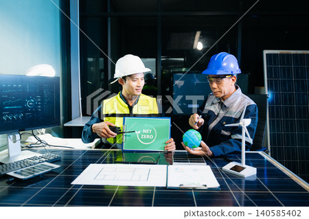 Engineers planning solar energy system for net zero goals. Renewable power, sustainability, green technology Engineers planning solar energy system for net zero goals. Renewable power, sustainability, green technology 140585402