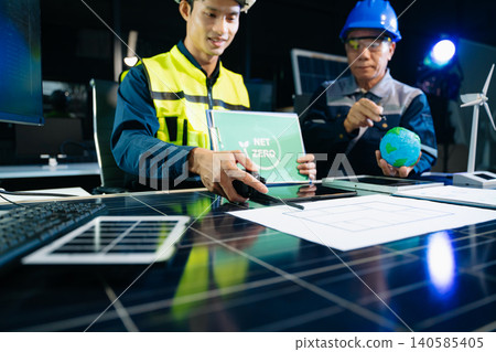 Engineers planning solar energy system for net zero goals. Renewable power, sustainability, green technology Engineers planning solar energy system for net zero goals. Renewable power, sustainability, green technology 140585405