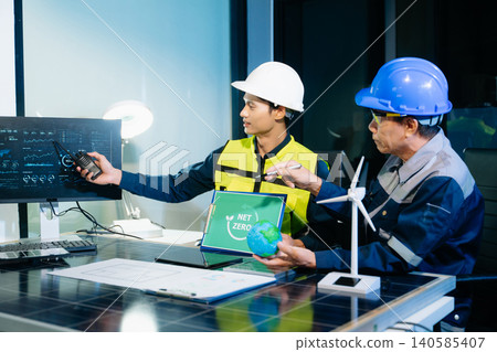 Engineers planning solar energy system for net zero goals. Renewable power, sustainability, green technology Engineers planning solar energy system for net zero goals. Renewable power, sustainability, green technology 140585407