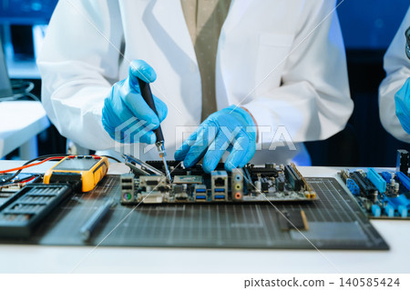 Technician repairing computer motherboard with soldering tools in a high-tech laboratory, focusing on electronics engineering, hardware diagnostics, cybersecurity Technician repairing computer motherboard with soldering tools in a high-tech laboratory, focusing on electronics engineering, hardware diagnostics, cybersecurity 140585424