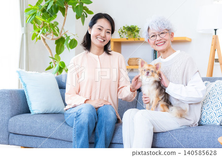 Family - Woman holding a Chihuahua Family - Woman holding a Chihuahua 140585628