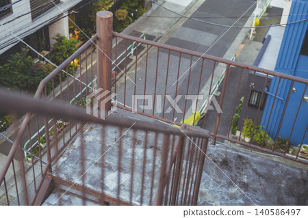 A view of a residential area from the exterior staircase of an apartment building. A view of a residential area from the exterior staircase of an apartment building. 140586497