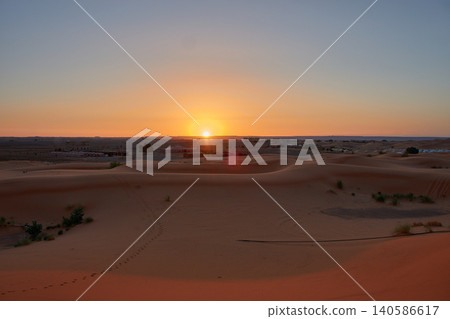 A stunning desert landscape reveals undulating textures in the twilight light of Merzouga, Morocco. A stunning desert landscape reveals undulating textures in the twilight light of Merzouga, Morocco. 140586617