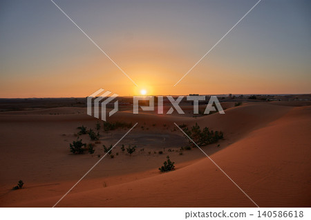 A stunning desert landscape reveals undulating textures in the twilight light of Merzouga, Morocco. 140586618