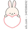 White rabbit peeking out from above the heart 140586692